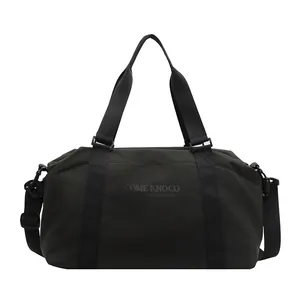 Front view of dark green large capacity travel duffel bag with shoulder strap and handles