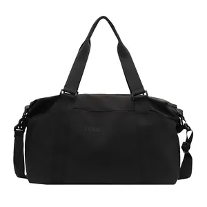 Detail view of black large capacity travel duffel bag with sturdy shoulder straps