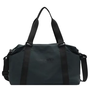 Detailed front view of a dark teal large capacity travel bag with durable shoulder straps