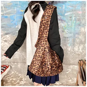 Back view of a large leopard print cotton tote bag on model showing size and texture
