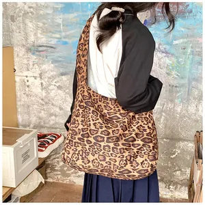 Stylish leopard print cotton tote bag shown on model's shoulder for casual daily use