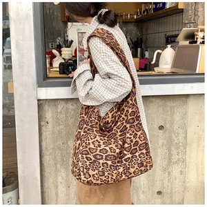 Leopard print cotton hobo bag worn by model, highlighting its large size and casual style.