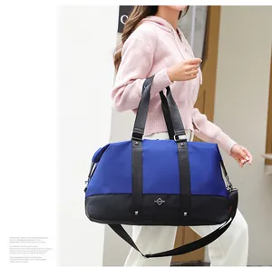 Stylish blue and black large capacity travel duffel bag for fitness and short trips.