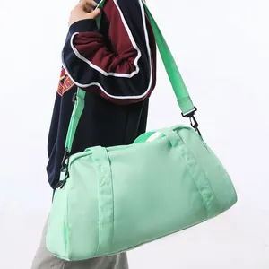 Stylish mint green large capacity sports duffel bag shown on a model against white backdrop