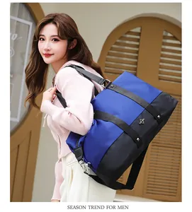 Asian female model carrying a large blue and black travel bag in a stylish outdoor setting