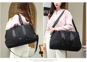 Lifestyle view of a large capacity black travel duffel bag carried by a model