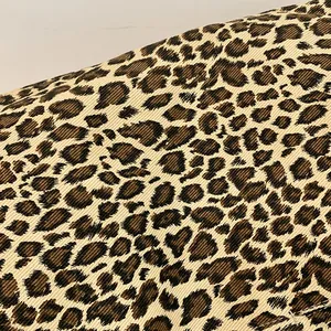 Close-up detail of leopard print cotton fabric showing the fine texture and pattern.
