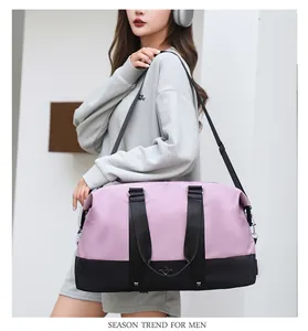Stylish pink and black large capacity travel bag carried by a model for gym or travel