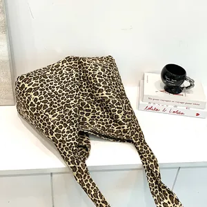 Stylish leopard print cotton tote bag for women shown in a cozy home lifestyle setting