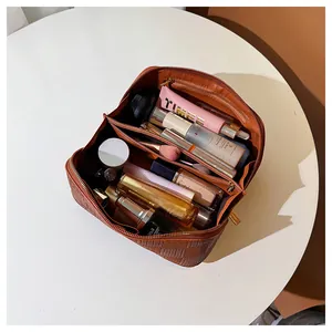 Detailed interior view of a checkered makeup bag showing its large storage capacity.