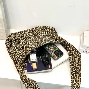 Detailed view of leopard print cotton tote bag with everyday essentials inside storage