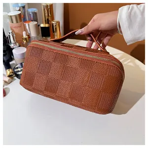 Macro detail of the elegant brown checkered texture on a square cosmetic travel bag