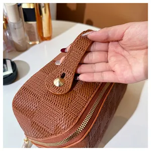 Close-up of premium brown checkered woven texture on a portable square cosmetic bag
