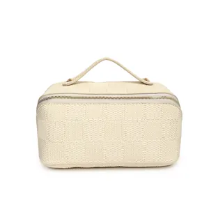 Close-up front view of a minimalist cream checkered texture portable cosmetic storage bag