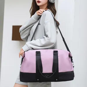 Stylish large capacity pink and black travel duffel bag for women shown with model