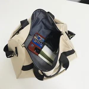 Große beige Reisetasche mit schwarzen Riemen und geräumigem Innenraum