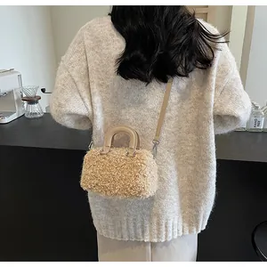 Lifestyle detail of a beige faux fur small square bag with leather strap and handle