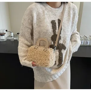 Detailed view of the soft plush teddy material on the cream-colored mini box handbag