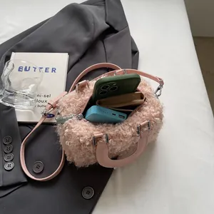 Pink curly plush mini box bag showing interior capacity with phone and accessories