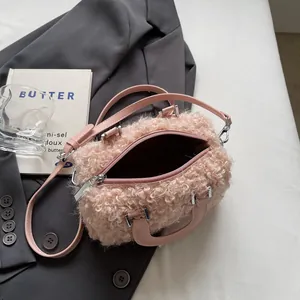 Detail view of pink plush crossbody bag with soft faux fur texture and silver hardware.