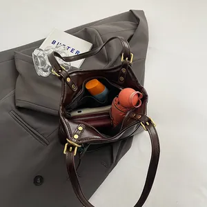 Large capacity interior view of a vintage dark brown leather-like tote bag for daily commuting