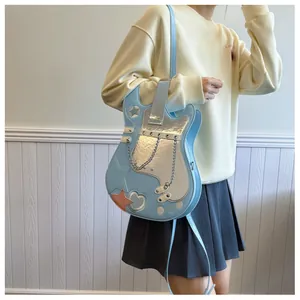 Model carrying a creative blue guitar-shaped crossbody bag with silver metallic star details