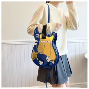 Creative blue and gold guitar-shaped crossbody handbag for women with chain detail.