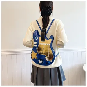Detail view of a creative blue and gold guitar-shaped backpack on a female model