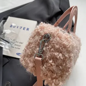 Close-up detail of a pink fluffy fleece box bag featuring silver metal hardware.