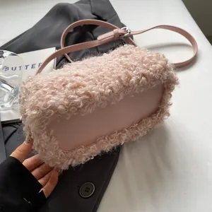Detailed view of pink plush shoulder bag showing soft fur texture and smooth base