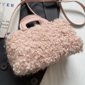 Close-up of a stylish pink curly faux fur handbag with elegant top handle design.