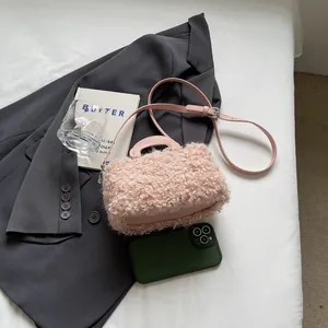 Close-up view of pink fuzzy sherpa box bag featuring a soft leather handle and strap