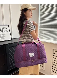 Purple quilted travel bag for gym and short trips, carried by a model in a room.