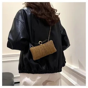 Detailed view of the gold pleated glitter evening clutch bag with elegant chain strap