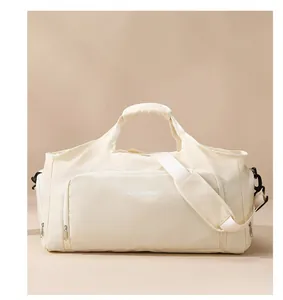 Detail of a large cream travel duffle bag for gym and short trips with shoulder strap