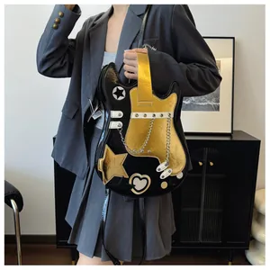 Unique guitar-shaped crossbody bag with gold chain and star accents worn by a model