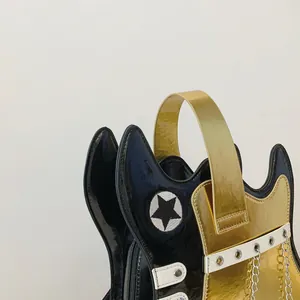 Close-up detail of creative guitar-shaped handbag with gold finish and star patch