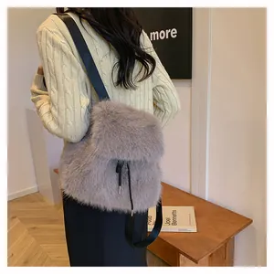 Stylish grey faux fur backpack for women shown being worn in a casual indoor setting