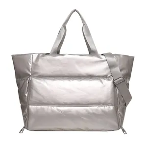 Detailed view of silver quilted large capacity travel tote bag with shoulder strap