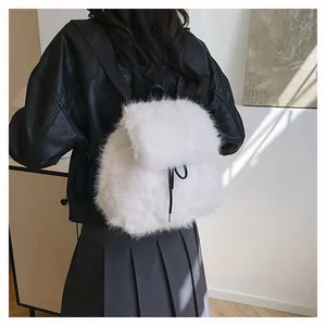 Detail view showing a fluffy white faux fur backpack with black drawstring strap