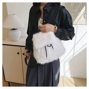 Detail shot of a white faux fur bucket backpack worn by a model in casual style