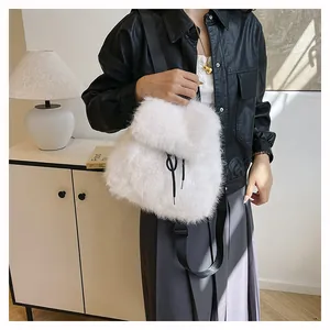 Detailed view of the white plush faux fur backpack with black drawstring accents
