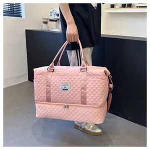 Pink quilted travel bag with shoe compartment shown in a lifestyle gym setting