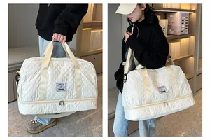 Detail showing the quilted fabric and double-layered storage of the white travel bag