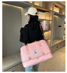 Pink quilted travel bag with dry-wet separation bottom compartment carried by model.