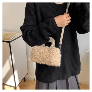 Stylish beige fuzzy square handbag with handle and shoulder strap in lifestyle setting