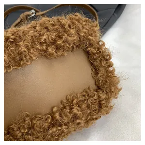 Detailed close-up showing the soft brown plush texture and smooth faux leather on the bag