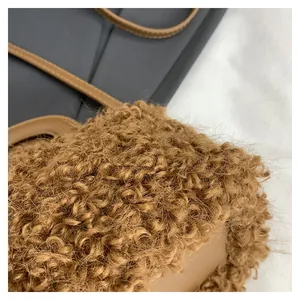 Close-up of brown plush teddy fur texture and tan leather strap stitching.