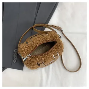 Detailed view of brown fuzzy square handbag showing zipper closure and spacious interior