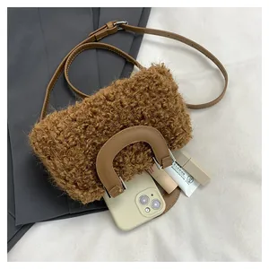 Detail view of a brown fuzzy square handbag showing its capacity with daily essentials.